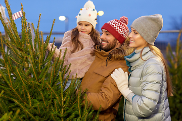 Image showing happy family choosing christmas tree at market