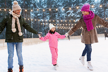 Image showing happy family at outdoor skating rink in winter