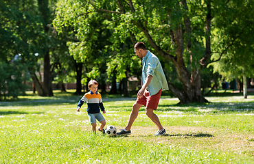 Image showing father with little son playing soccer at park