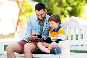 Image showing father and son with smartphone at park