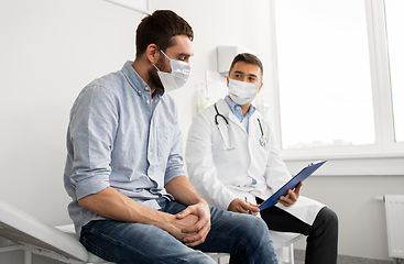 Image showing male doctor and patient in masks at hospital