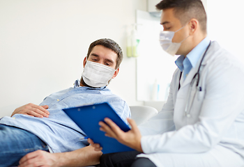 Image showing male doctor and patient in masks at hospital