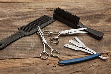 Image showing Barber shop equipment set isolated on wooden table background.