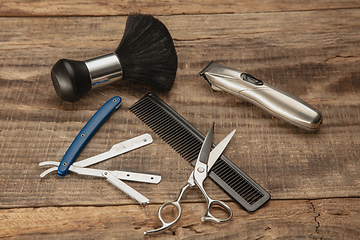 Image showing Barber shop equipment set isolated on wooden table background.