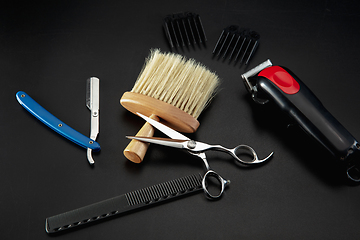 Image showing Barber shop equipment set isolated on black table background.