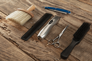 Image showing Barber shop equipment set isolated on wooden table background.