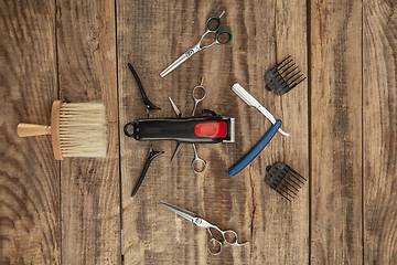 Image showing Barber shop equipment set isolated on wooden table background.