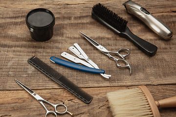 Image showing Barber shop equipment set isolated on wooden table background.