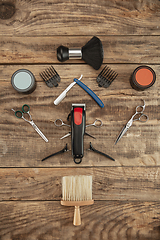 Image showing Barber shop equipment set isolated on wooden table background.