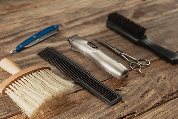 Image showing Barber shop equipment set isolated on wooden table background.