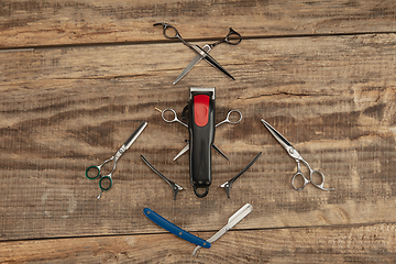 Image showing Barber shop equipment set isolated on wooden table background.