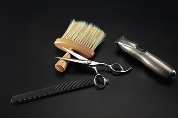 Image showing Barber shop equipment set isolated on black table background.