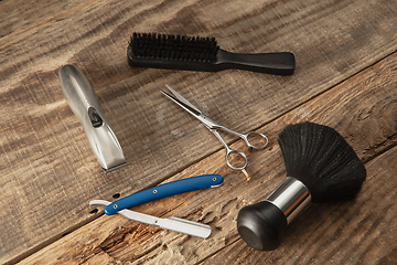 Image showing Barber shop equipment set isolated on wooden table background.