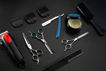 Image showing Barber shop equipment set isolated on black table background.