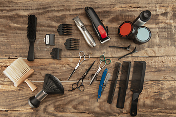 Image showing Barber shop equipment set isolated on wooden table background.