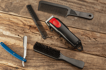 Image showing Barber shop equipment set isolated on wooden table background.