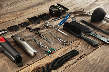 Image showing Barber shop equipment set isolated on wooden table background.