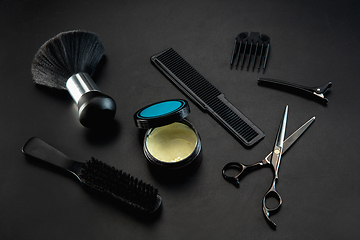 Image showing Barber shop equipment set isolated on black table background.