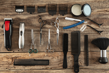 Image showing Barber shop equipment set isolated on wooden table background.