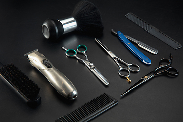 Image showing Barber shop equipment set isolated on black table background.