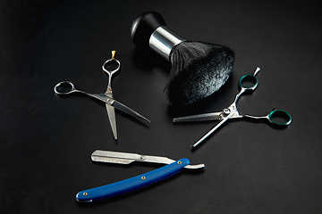 Image showing Barber shop equipment set isolated on black table background.