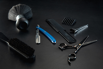 Image showing Barber shop equipment set isolated on black table background.