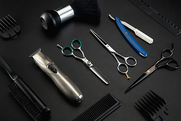 Image showing Barber shop equipment set isolated on black table background.