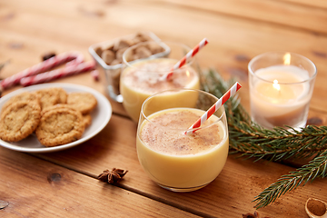 Image showing glasses of eggnog, oatmeal cookies and fir branch