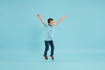 Image showing Childhood and dream about big and famous future. Pretty little boy isolated on blue background