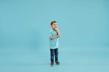 Image showing Childhood and dream about big and famous future. Pretty little boy isolated on blue background