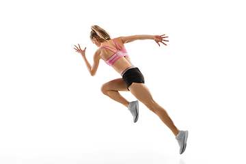 Image showing Caucasian professional female runner, athlete training isolated on white studio background. Copyspace for ad.