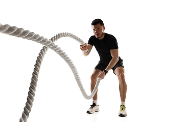 Image showing Caucasian professional sportsman training isolated on white studio background. Muscular, sportive man practicing.