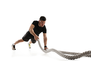 Image showing Caucasian professional sportsman training isolated on white studio background. Muscular, sportive man practicing.