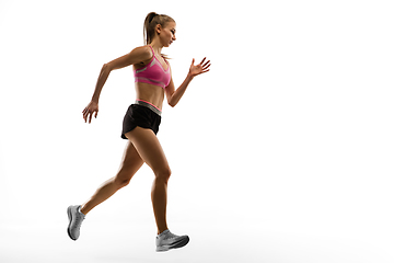 Image showing Caucasian professional female runner, athlete training isolated on white studio background. Copyspace for ad.