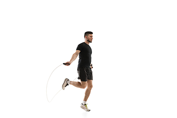 Image showing Caucasian professional sportsman training isolated on white studio background. Muscular, sportive man practicing.