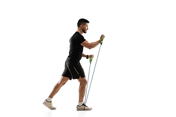 Image showing Caucasian professional sportsman training isolated on white studio background. Muscular, sportive man practicing.