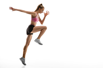 Image showing Caucasian professional female runner, athlete training isolated on white studio background. Copyspace for ad.