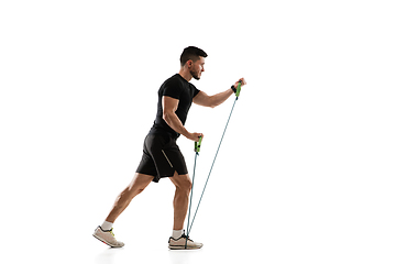 Image showing Caucasian professional sportsman training isolated on white studio background. Muscular, sportive man practicing.