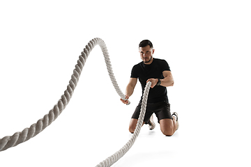 Image showing Caucasian professional sportsman training isolated on white studio background. Muscular, sportive man practicing.