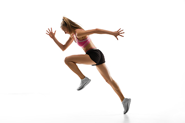 Image showing Caucasian professional female runner, athlete training isolated on white studio background. Copyspace for ad.