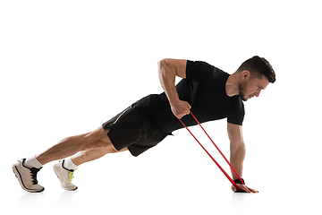 Image showing Caucasian professional sportsman training isolated on white studio background. Muscular, sportive man practicing.