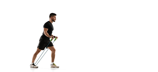 Image showing Caucasian professional sportsman training isolated on white studio background. Muscular, sportive man practicing.