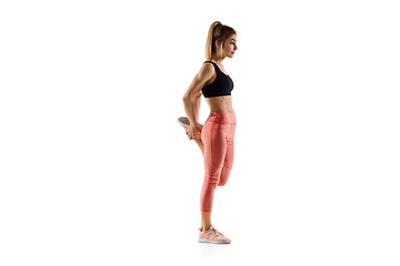 Image showing Young caucasian female model in action, motion isolated on white background. Concept of sport, movement, energy and dynamic, healthy lifestyle. Training, practicing.