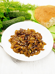 Image showing Cucumber fried in plate on wooden table