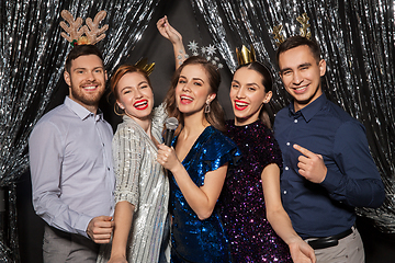 Image showing friends with microphone singing at christmas party