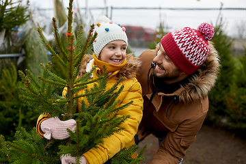 Image showing happy family choosing christmas tree at market