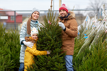 Image showing happy family choosing christmas tree at market