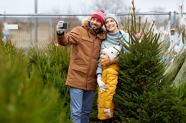 Image showing family taking selfie with christmas tree at market