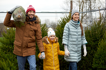 Image showing happy family buying christmas tree at market