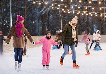 Image showing happy family at outdoor skating rink in winter